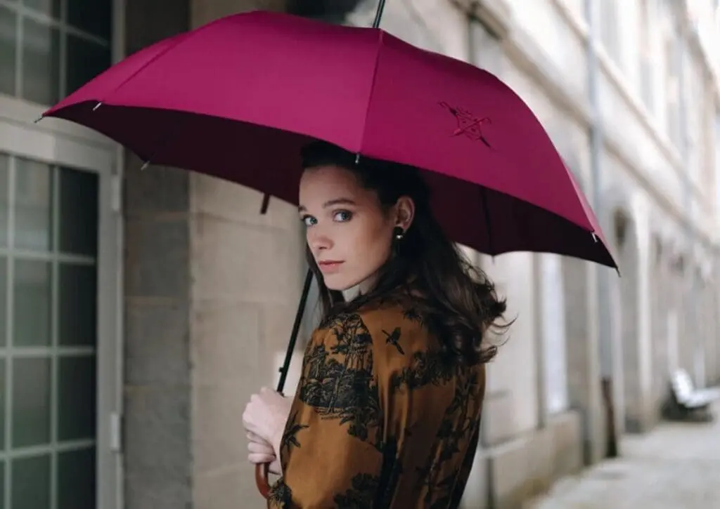 Portrait of a woman carrying a pink Cherbourg umbrella
